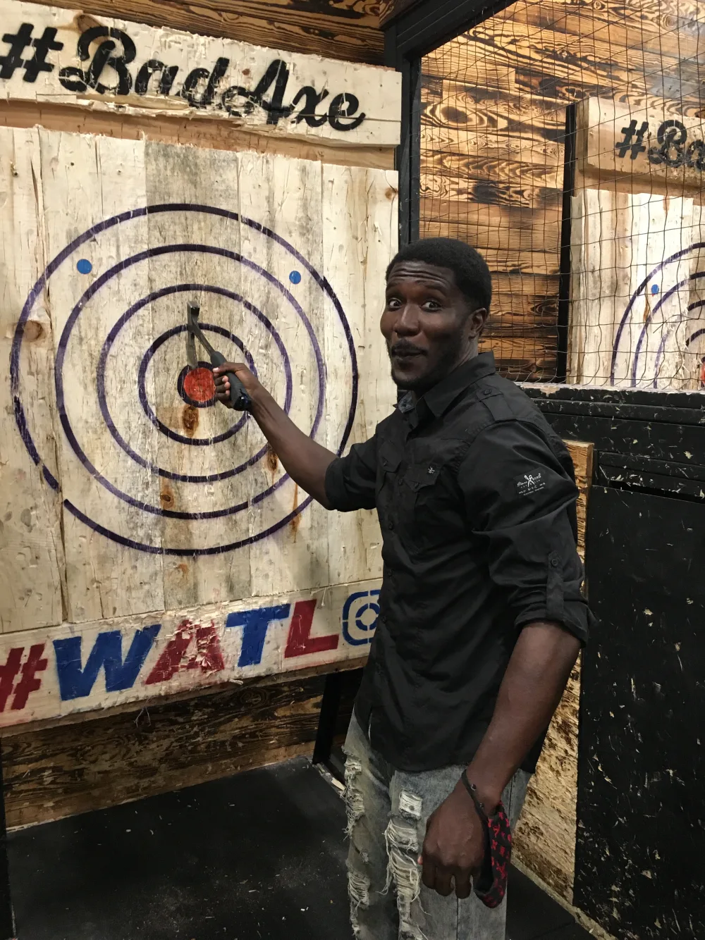 A Barone team member enjoying an axe-throwing company outing